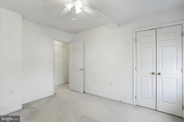 an empty room with a ceiling fan