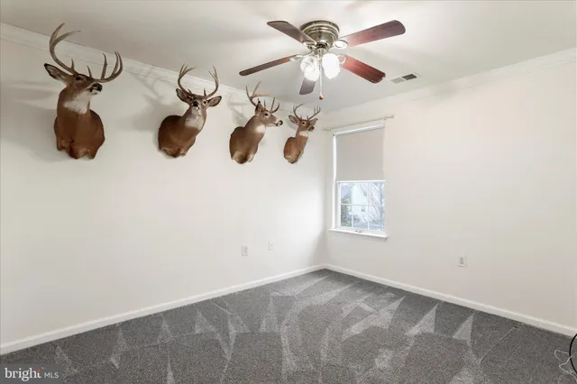 a view of a room with a ceiling fan