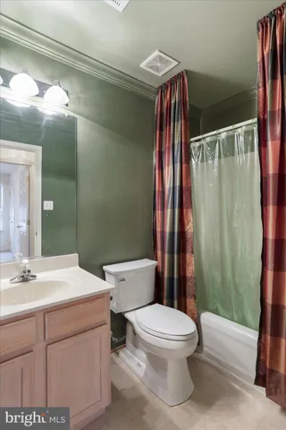 a bathroom with a toilet a sink and shower