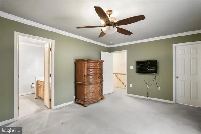a view of an empty room and kitchen