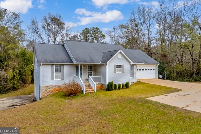 a view of a house with pool and yard