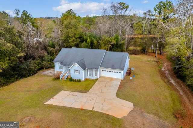 a view of a lake with a yard and a large window