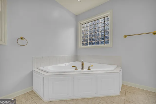 an empty room with a window and ceiling fan