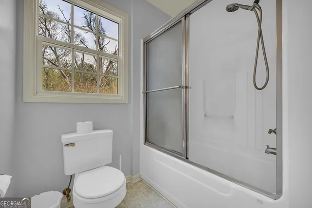 a view of empty room with fireplace and fan