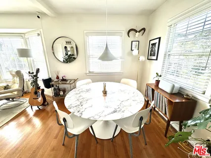 a view of a dining room with furniture and a large window