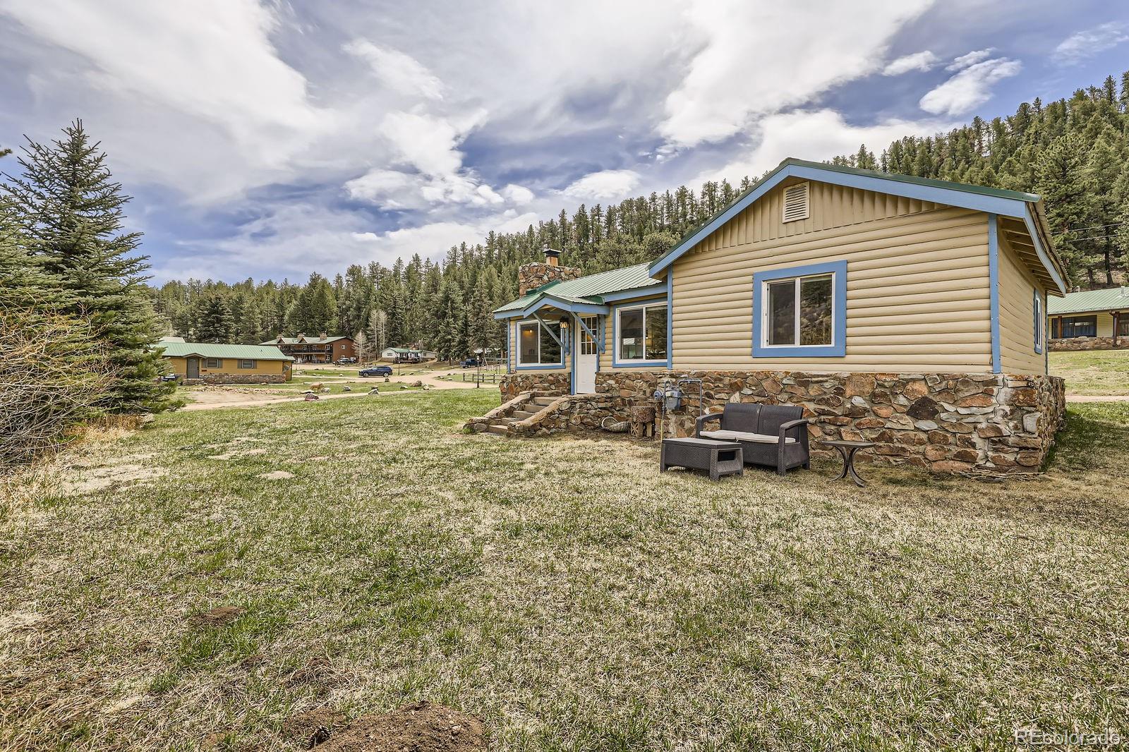 57920 US Highway 285, Unit 8 Bailey, CO 80421 - Photo 18 of 29 a backyard of a house with table and chairs