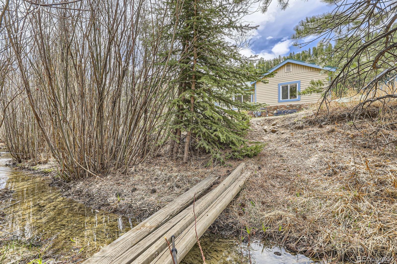 57920 US Highway 285, Unit 8 Bailey, CO 80421 - Photo 19 of 29 a view of a house with a yard