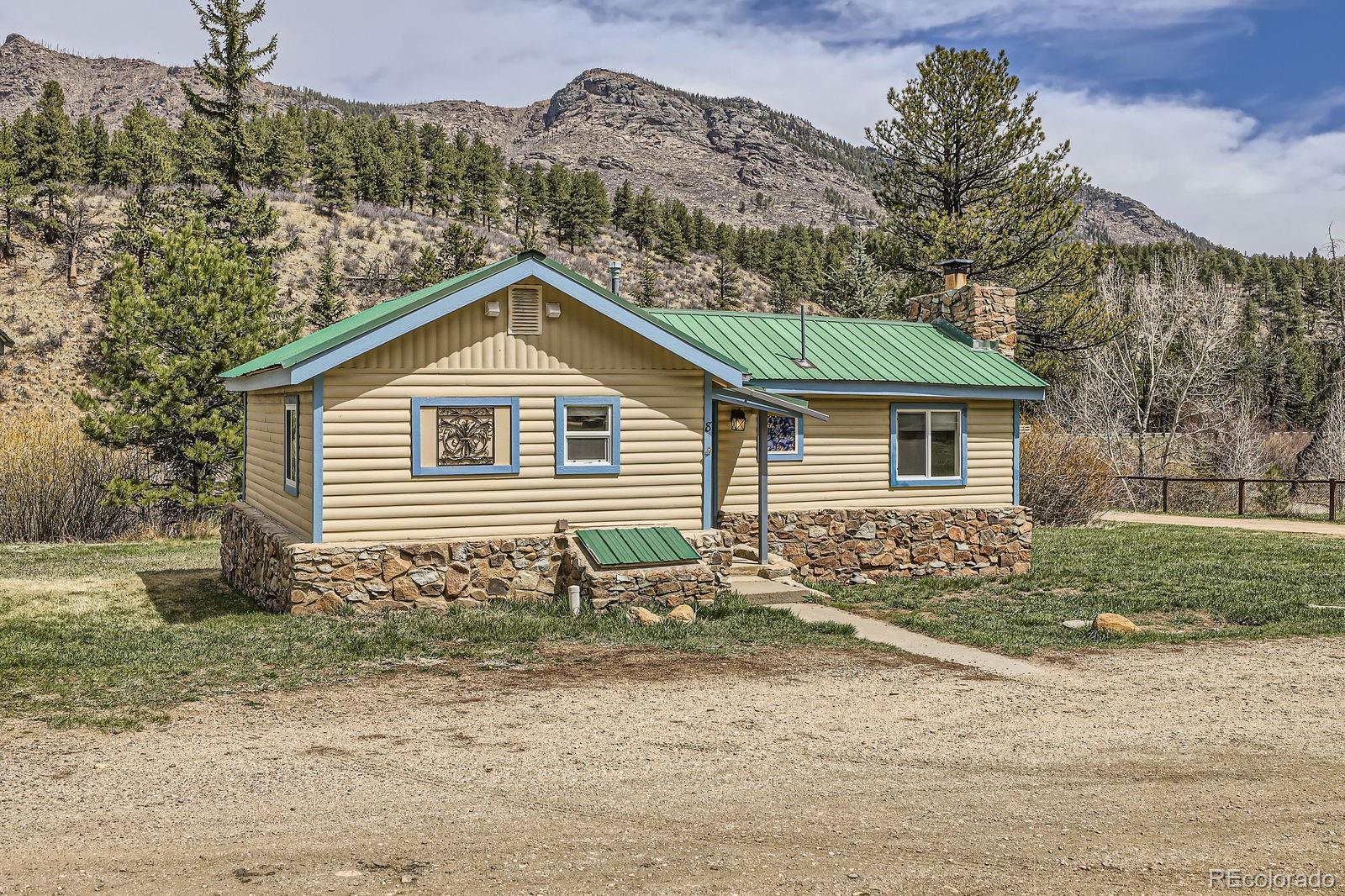 57920 US Highway 285, Unit 8 Bailey, CO 80421 - Photo 2 of 29 a front view of a house with a yard