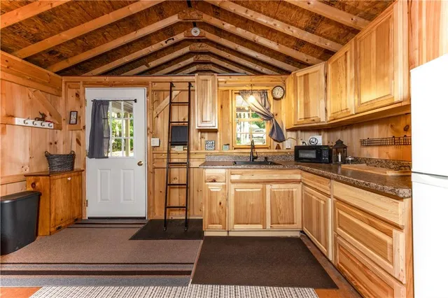 a kitchen with stainless steel appliances granite countertop a refrigerator and cabinets