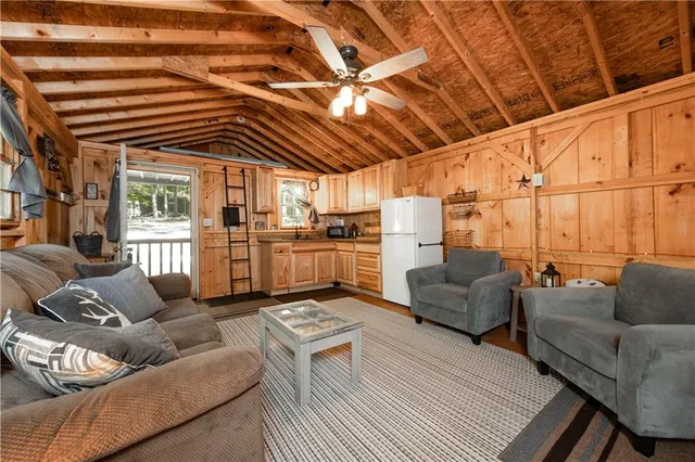 a living room with furniture a ceiling fan and a rug