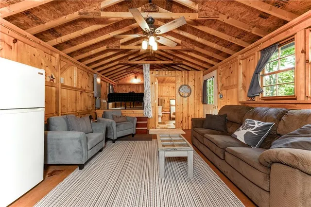 a living room with furniture a wooden floor and next to a window