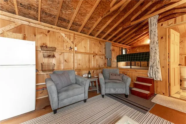 a living room with furniture a flat screen tv and kitchen view