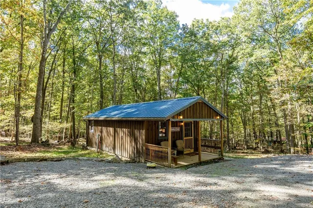a view of a house with a yard and sitting area