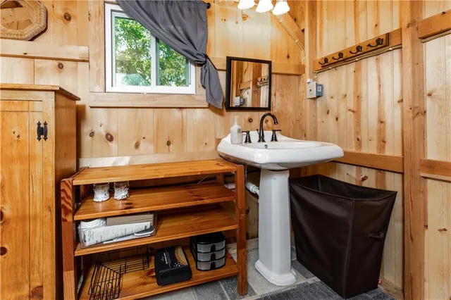 a bathroom with a sink a toilet and a window