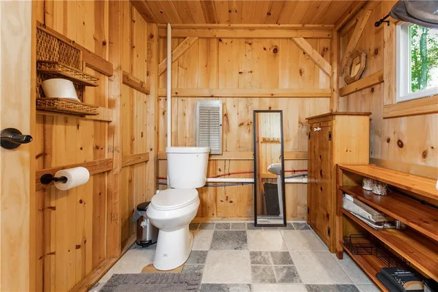 a bathroom with a toilet and a shower