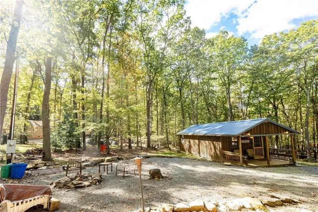 a backyard of a house with barbeque oven table and chairs