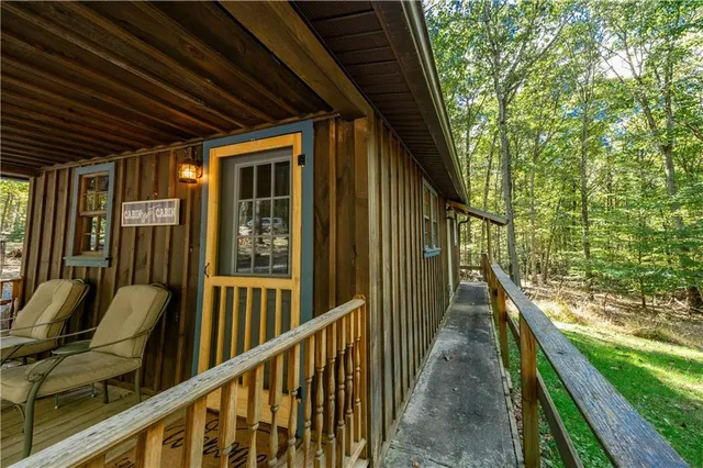 a view of balcony with wooden floor and fence