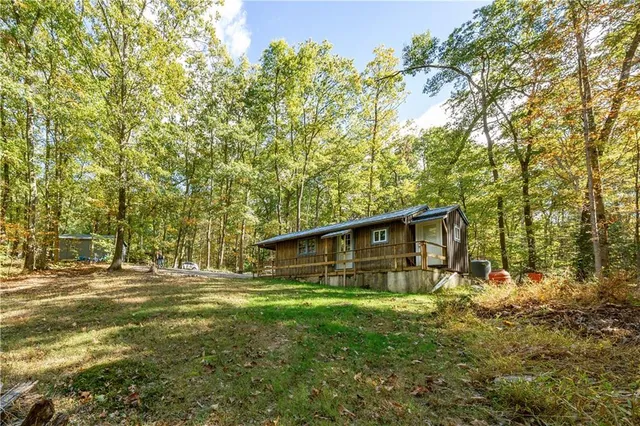 a backyard of a house with table and chairs