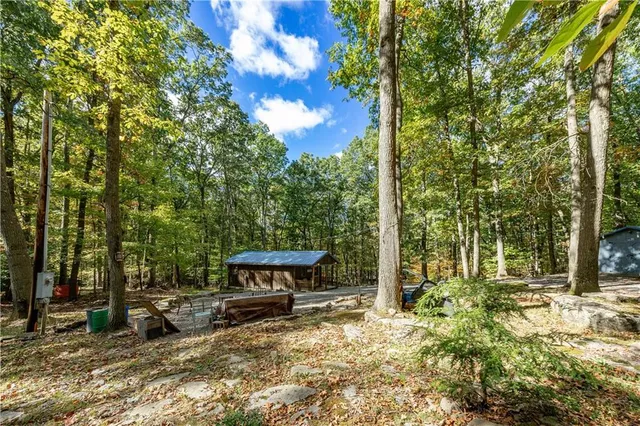a view of a bench in the backyard of a house