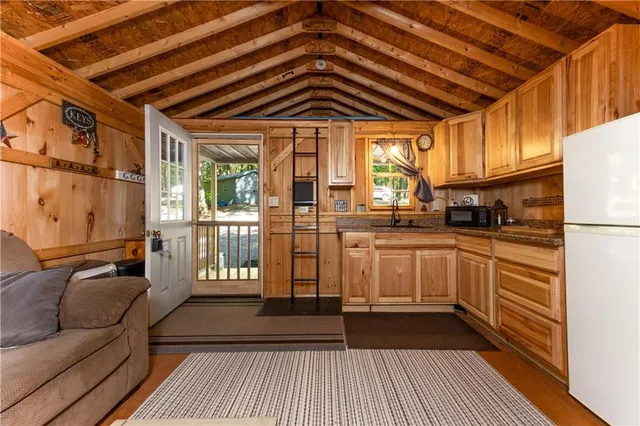 a kitchen with a sink a counter top space and stainless steel appliances