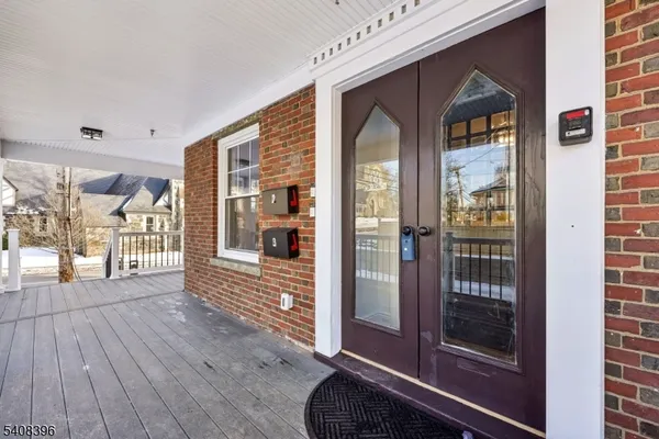 a view of front door of house and living room