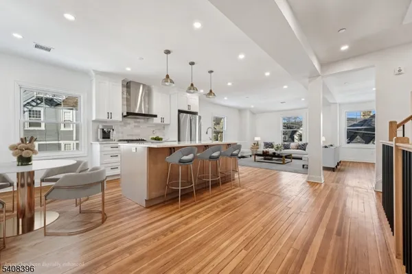 a large kitchen with stainless steel appliances lots of counter space and windows