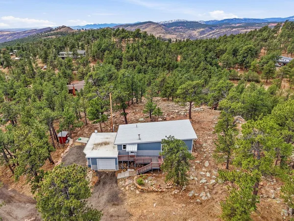 an aerial view of a house with a yard