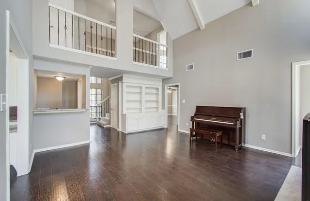a view of livingroom with furniture wooden floor and windows