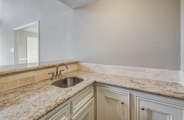 a kitchen with a sink and cabinets