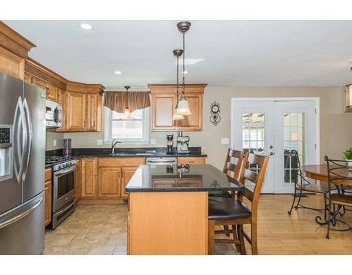 38 Old Bolton Road Hudson, MA 01749 - Photo 3 of 30 a kitchen with granite countertop a refrigerator stove top oven dining table and chairs