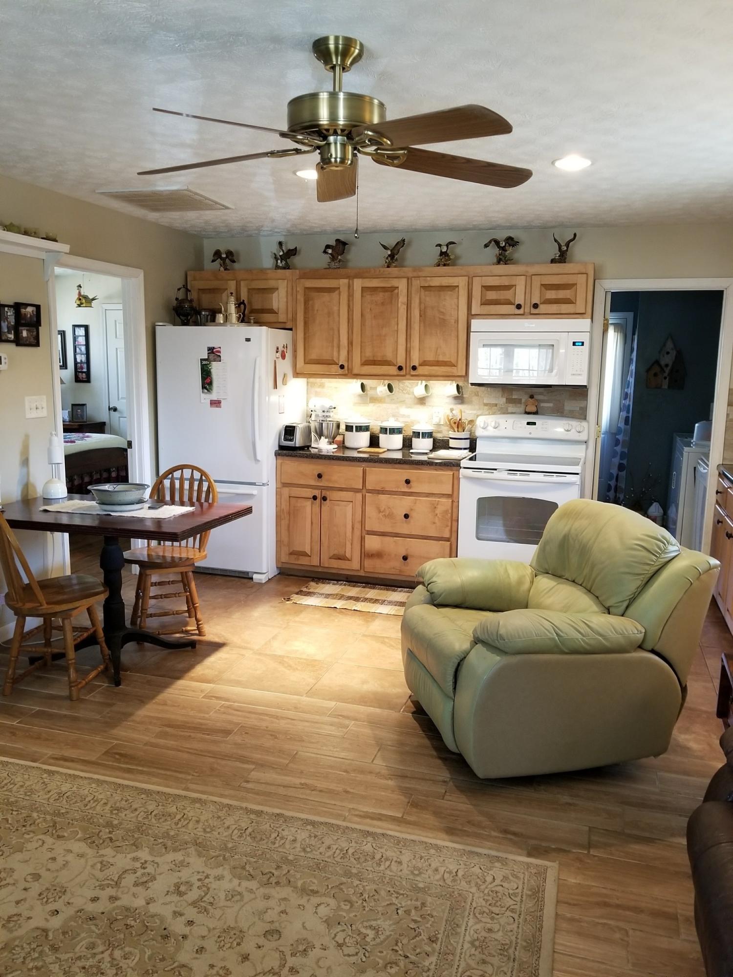 6575 Blacksburg Road Catawba, VA 24070 - Photo 3 of 14 a living room with stainless steel appliances kitchen island granite countertop furniture and a kitchen view