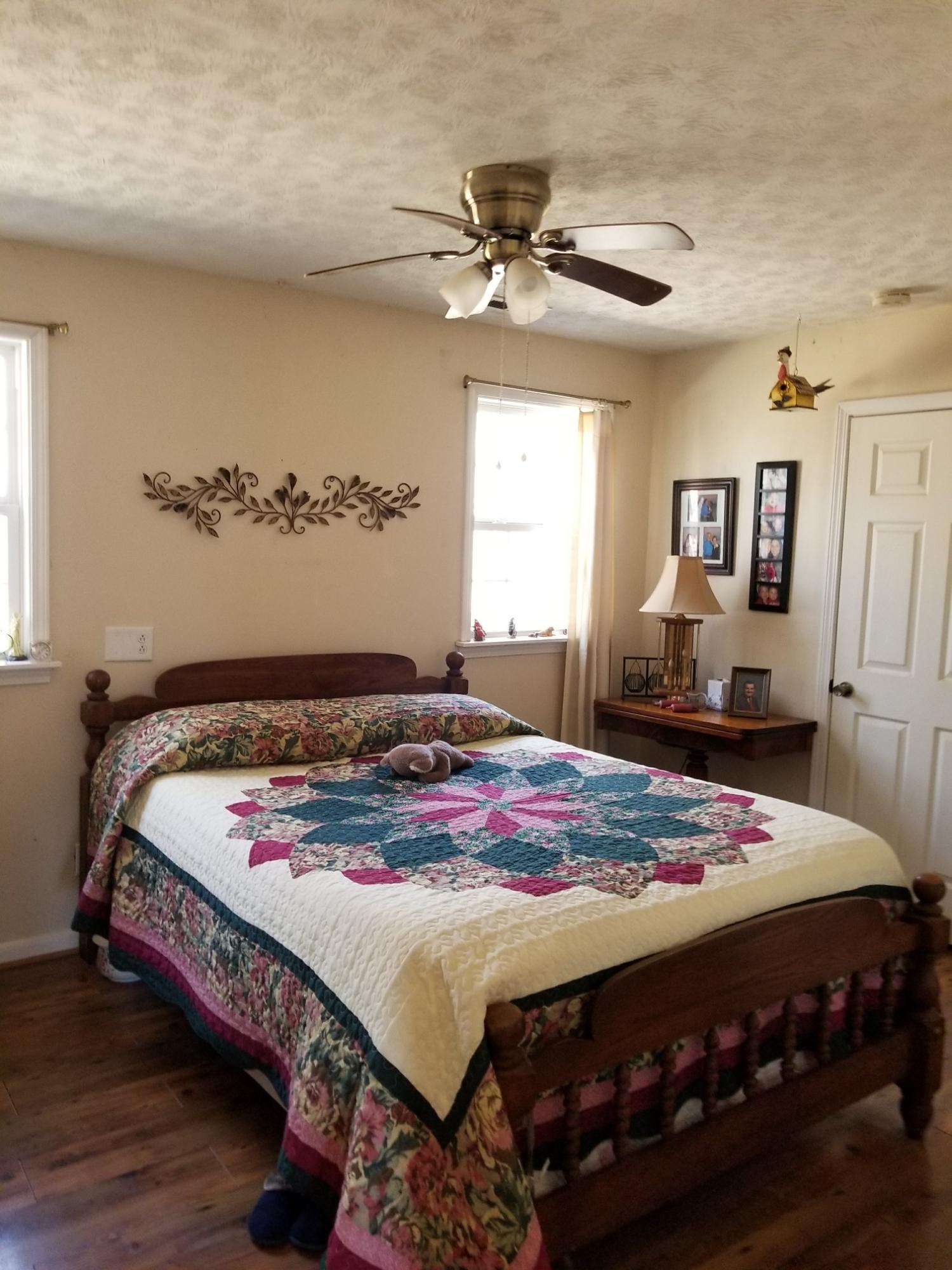 6575 Blacksburg Road Catawba, VA 24070 - Photo 5 of 14 a bedroom with a bed a dresser and window