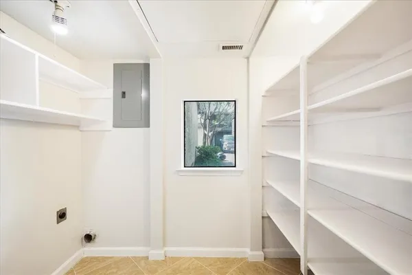 a view of walk in closet with empty racks