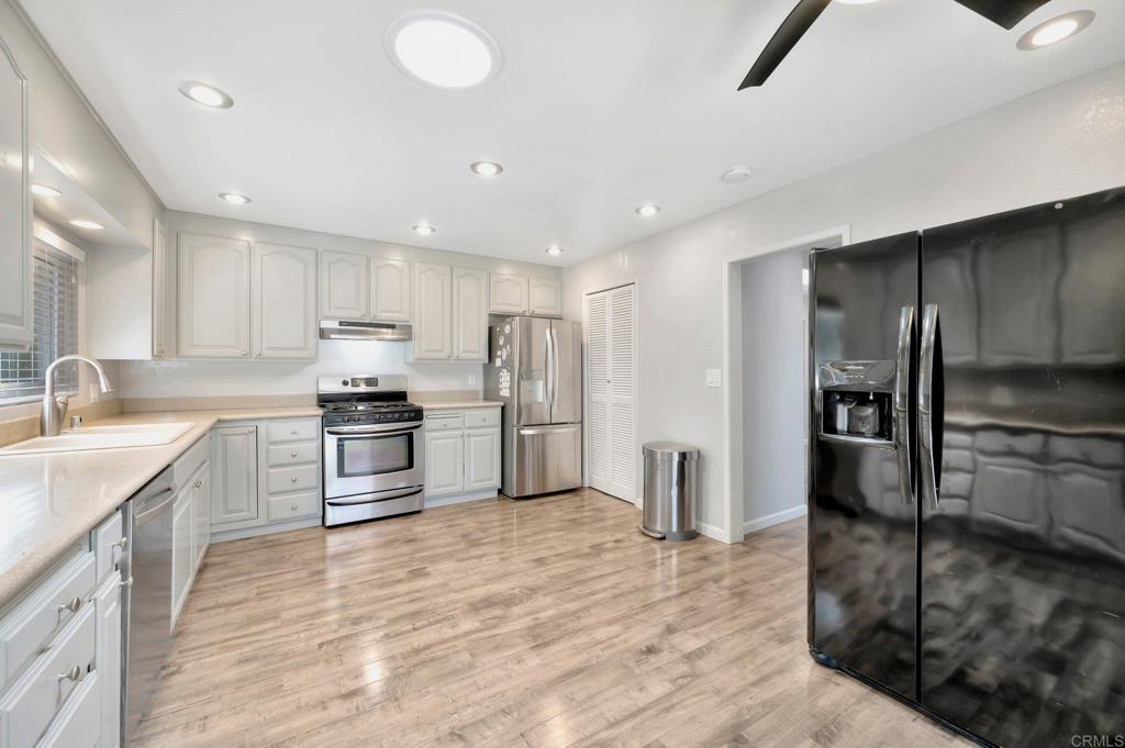 1601 Pepper Drive El Cajon, CA 92021 - Photo 12 of 31 a kitchen with granite countertop a refrigerator and a sink