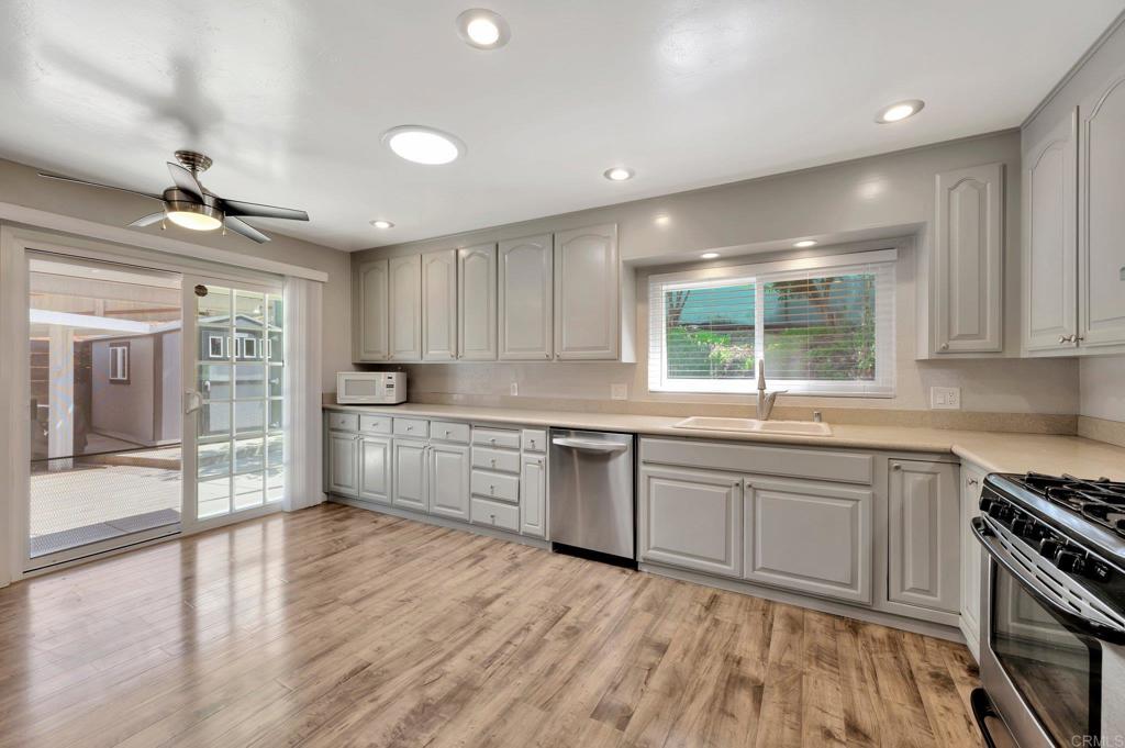1601 Pepper Drive El Cajon, CA 92021 - Photo 13 of 31 a kitchen with white cabinets and appliances