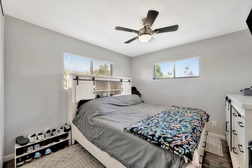 1601 Pepper Drive El Cajon, CA 92021 - Photo 19 of 31 a bedroom with a bed and a chandelier