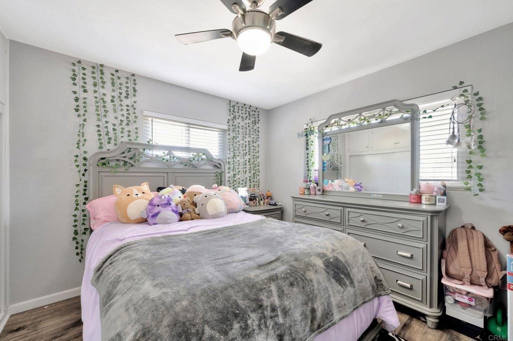 1601 Pepper Drive El Cajon, CA 92021 - Photo 21 of 31 a bedroom with a bed and a chandelier