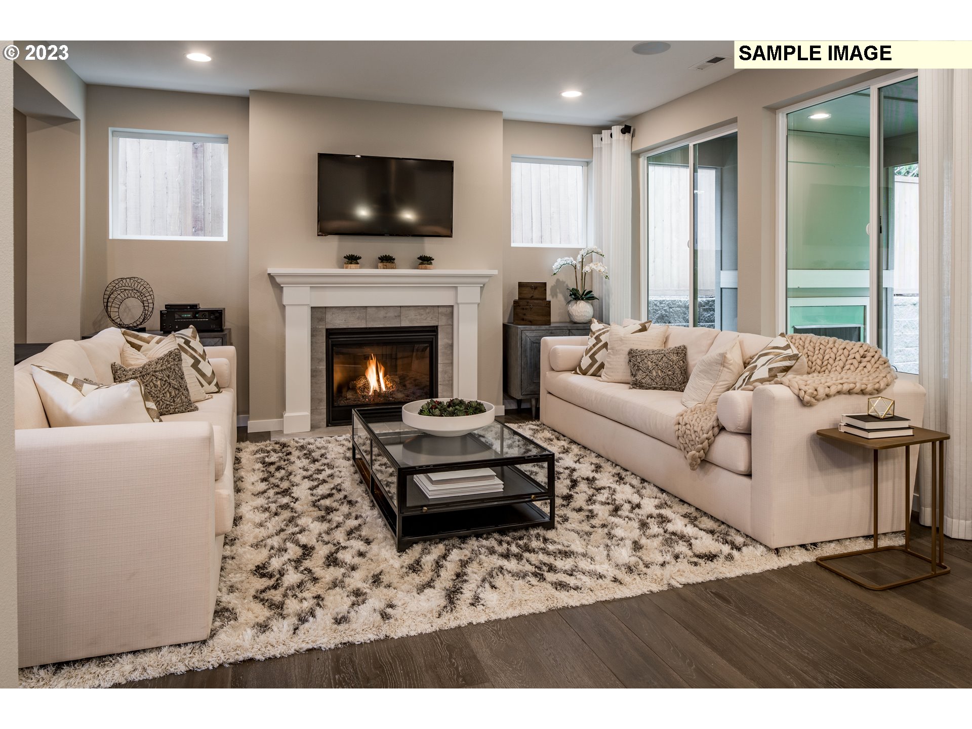 358 South 87th Avenue Ridgefield, WA 98642 - Photo 5 of 27 a living room with furniture a flat screen tv and a fireplace