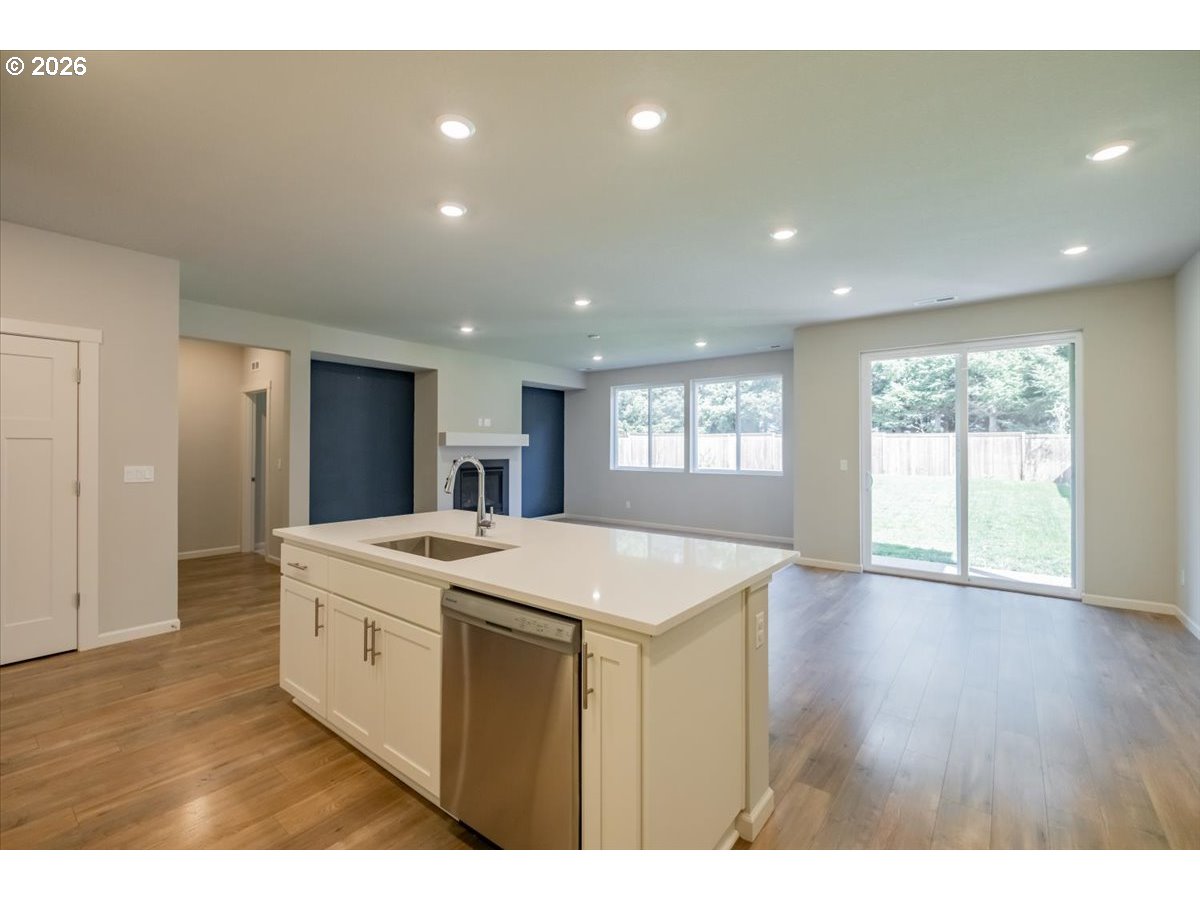 315 Cypress Street Mount Angel, OR 97362 - Photo 14 of 43 a open kitchen with a sink dishwasher a refrigerator and wooden floor