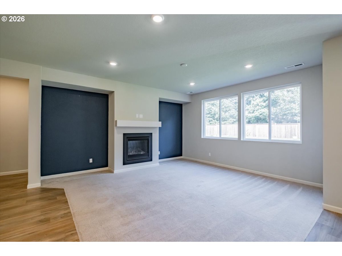315 Cypress Street Mount Angel, OR 97362 - Photo 15 of 43 a view of an empty room with a window and fireplace