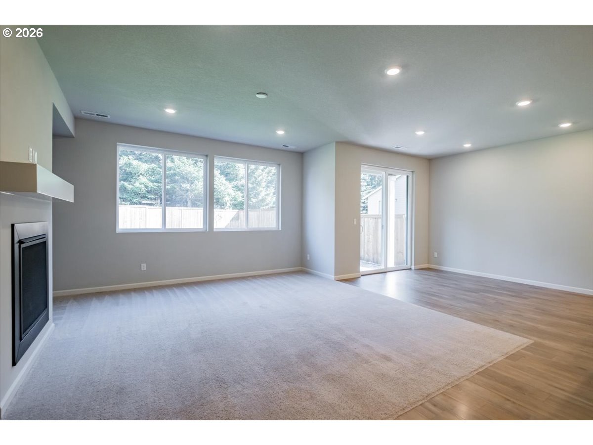 315 Cypress Street Mount Angel, OR 97362 - Photo 16 of 43 a view of an empty room with a window and fireplace