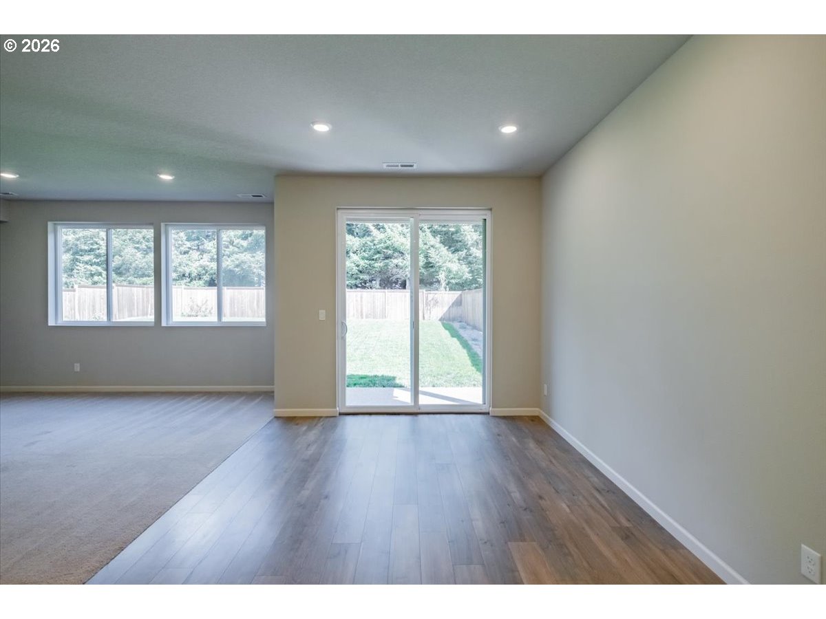 315 Cypress Street Mount Angel, OR 97362 - Photo 19 of 43 a view of an empty room with wooden floor and a window