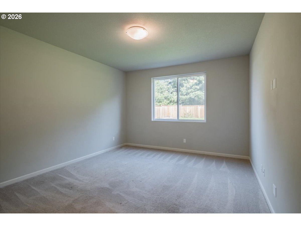 315 Cypress Street Mount Angel, OR 97362 - Photo 22 of 43 a view of an empty room with wooden floor and a window
