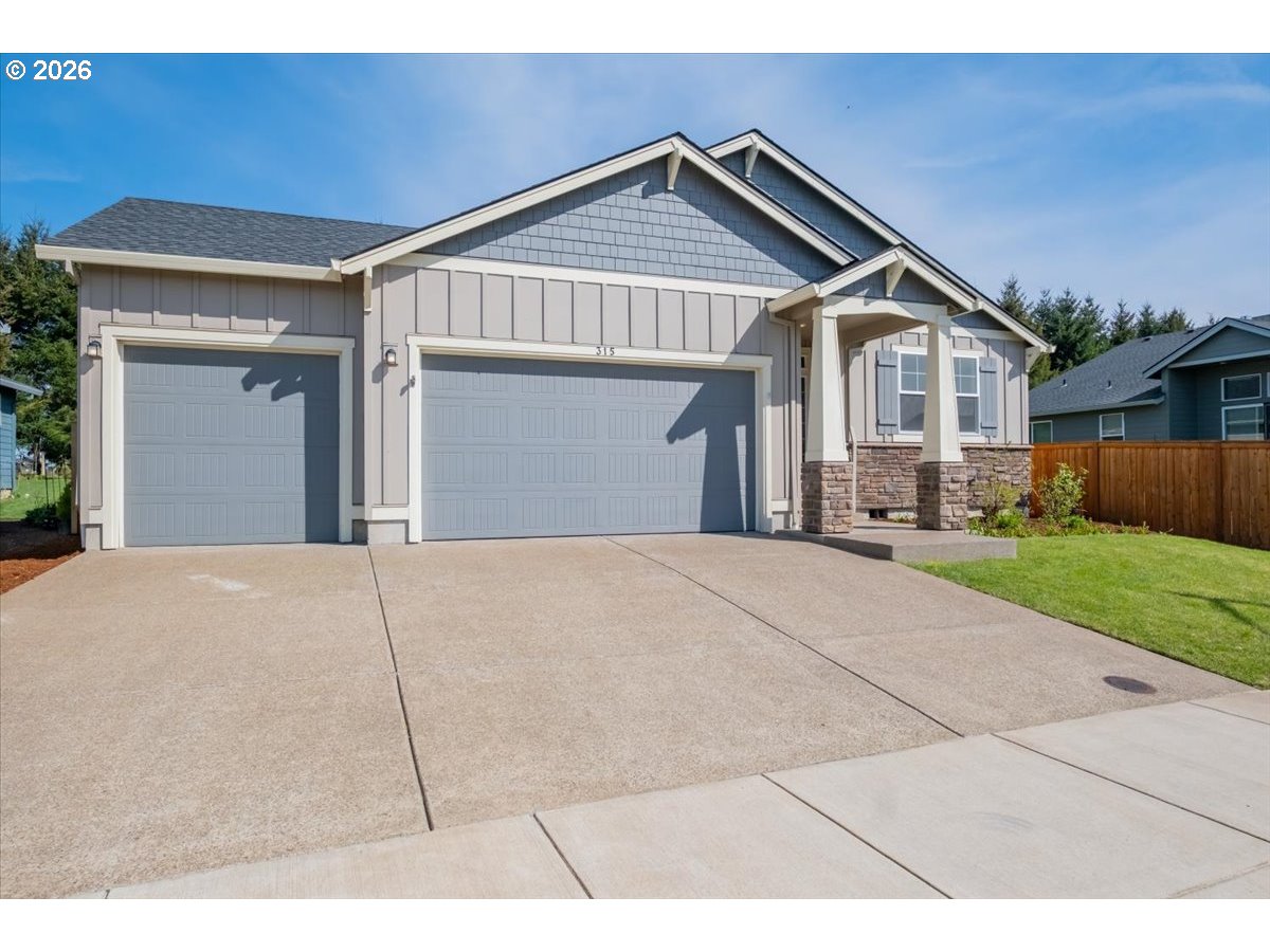 315 Cypress Street Mount Angel, OR 97362 - Photo 5 of 43 a front view of a house with a yard and garage