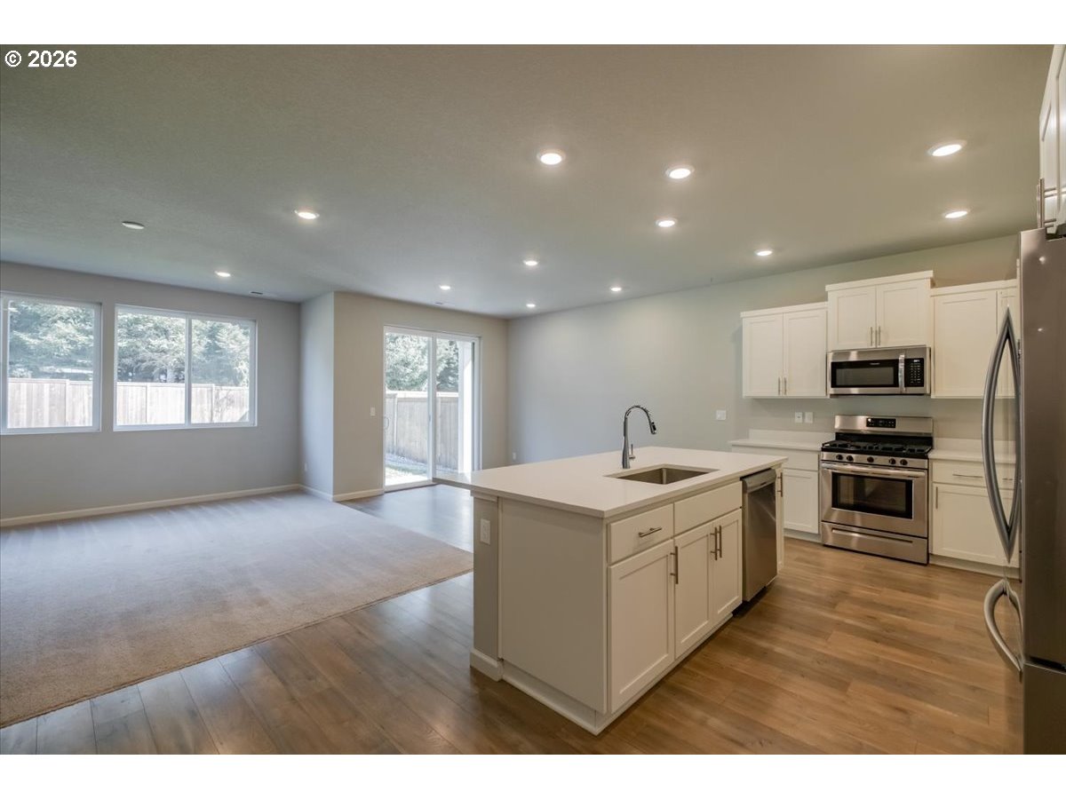 315 Cypress Street Mount Angel, OR 97362 - Photo 9 of 43 a kitchen with a sink wooden floor and stainless steel appliances