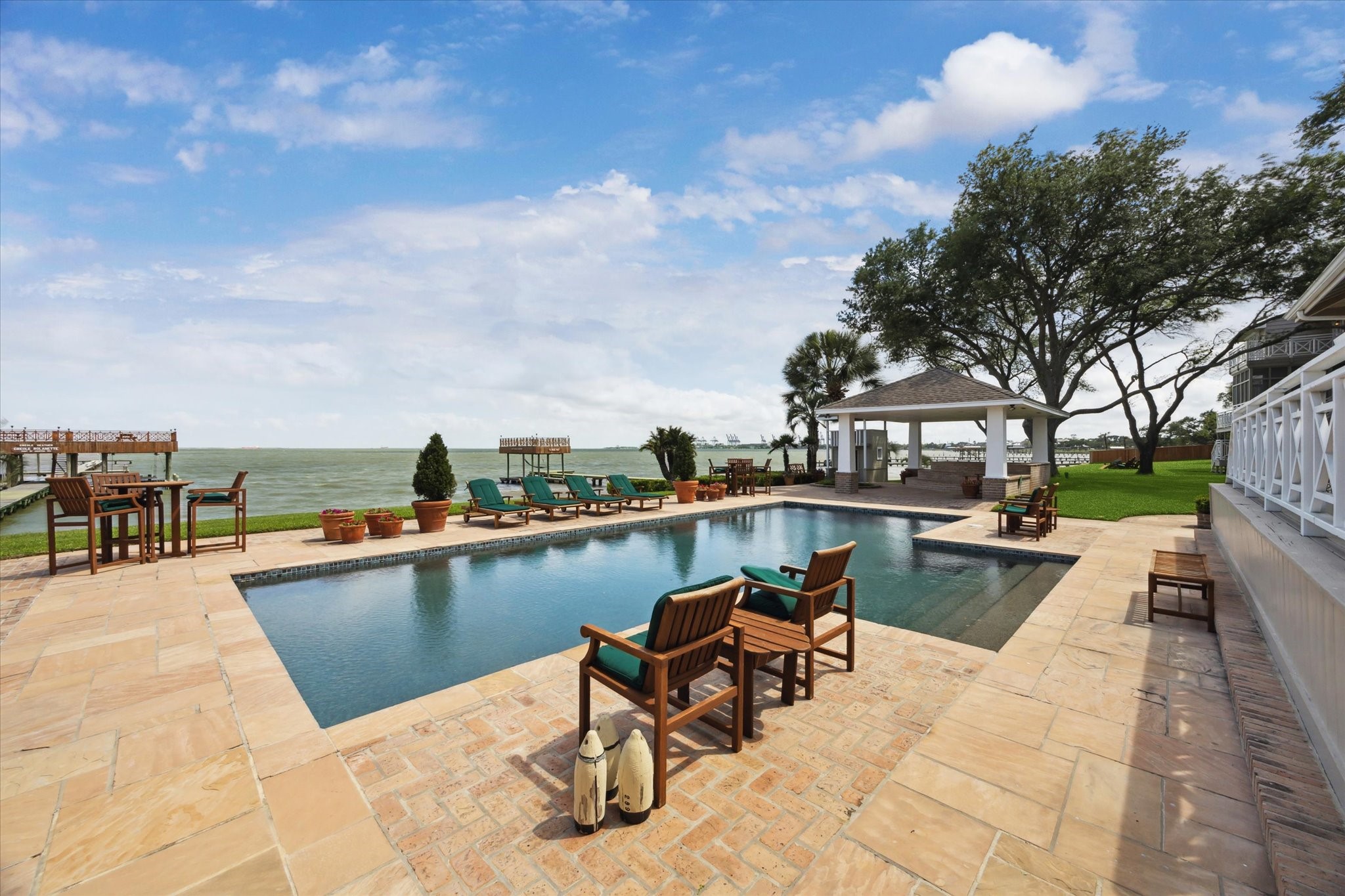 102 South R Street La Porte, TX 77571 - Photo 18 of 43 Another view of the pool from the covered outdoor kitchen and dining area outside the main house.