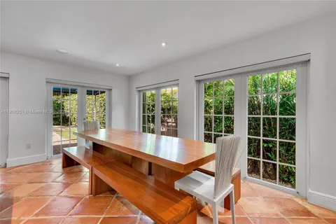 a room with pool table and windows