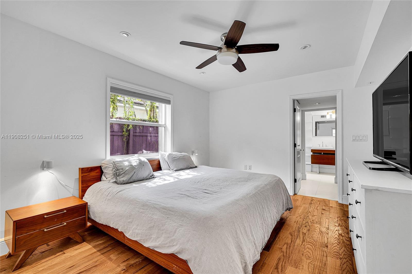 4150 Ventura Avenue Miami, FL 33133 - Photo 13 of 23 a bedroom with a bed and a flat tv screen on dresser