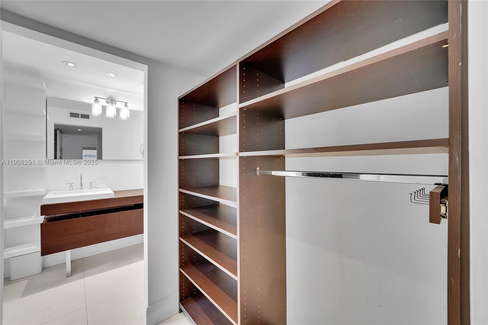 4150 Ventura Avenue Miami, FL 33133 - Photo 16 of 23 a view of walk in closet with empty racks