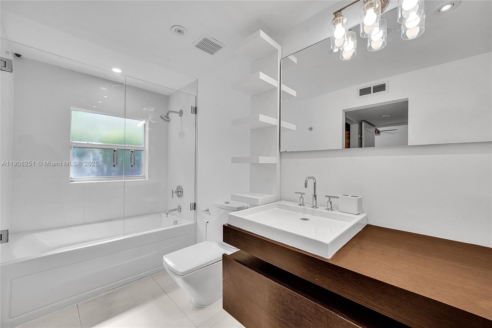 4150 Ventura Avenue Miami, FL 33133 - Photo 17 of 23 a bathroom with a sink a toilet and shower
